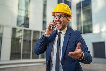 Happy architect receiving good news on phone