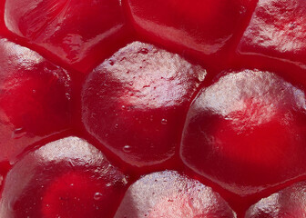 Close-up view of juicy pomegranate seeds glistening under natural light on a bright surface in afternoon hours