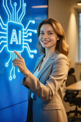A smiling young woman in a business suit pointing at a glowing blue AI circuit board display in an office setting.