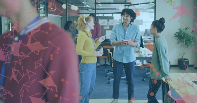 Talking colleagues, woman in mustard, sharing ideas in office, holding coffee and smartphone