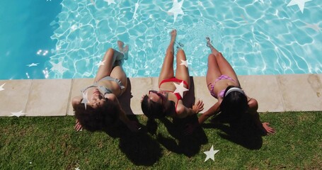 Reclining three women in bikinis basking at backyard pool, with shades headband coping star shapes