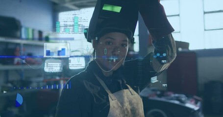 Lifting welding helmet, woman welder wearing leather apron standing at garage bay with AR overlays