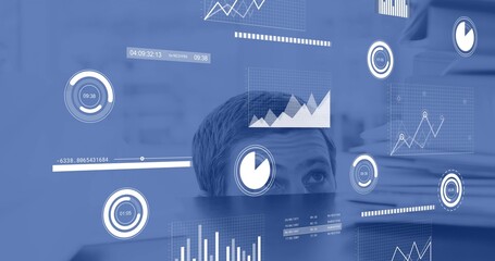 Peeking mid-adult man observing floating dashboard above dark monitor at office, with HUD charts