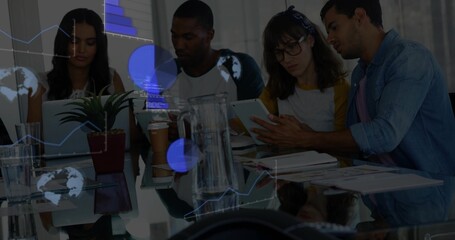 Pointing man in denim shirt directing five coworkers around glass table, with tablet and charts