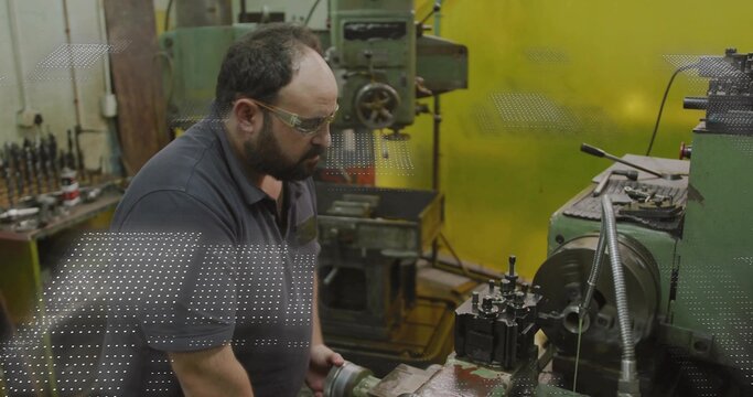 Turning machinist leaning over lathe chuck in machine shop, wearing safety glasses and polo - Powered by Adobe