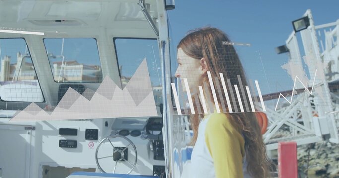 Standing teenage girl yellow top peering into motorboat helm at marina, digital charts, copy space - Powered by Adobe