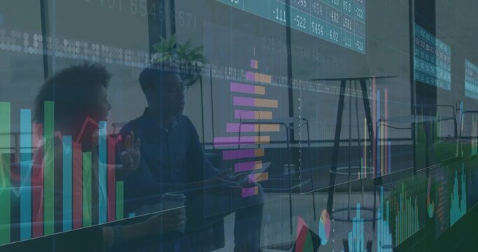 Talking team wearing business casual and blazer gesturing over overlay charts and laptop at office