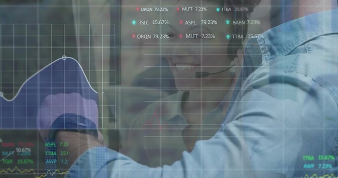 Pointing man in blue shirt extending arm toward glass display at office, with headset and charts