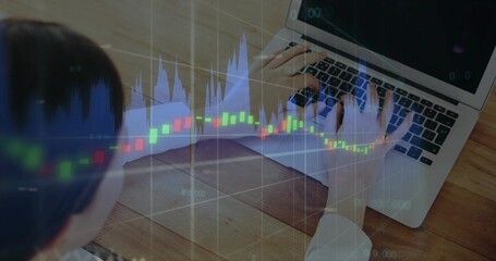 Typing woman in white shirt on silver laptop at wooden desk with pad, candlestick blue-line overlay