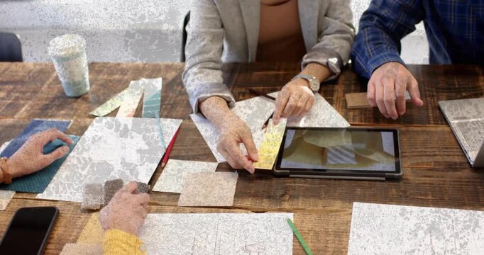 Design team reaching for tiles, starting tablet overlay showing swatch and lining cubes for choice