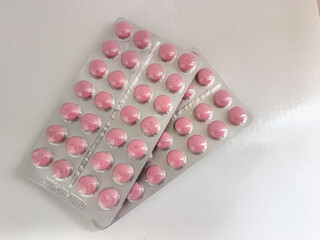 Pink round pills 2 blisters, top  view with copy space
