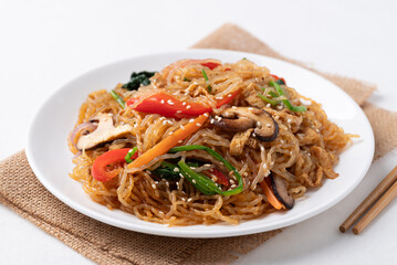 Japchae, Korean stir fried glass noodles with vegetables, pork, soy sauce and sesame oil