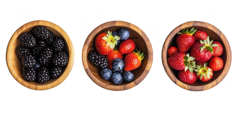 A display of fresh blackberries. blueberries. and strawberries arranged in wooden bowls against a clean white background. ideal for healthy eating promotions or culinary use