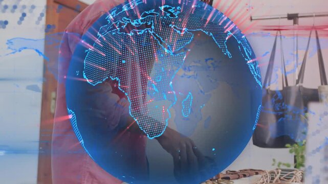 Man answering phone and dispensing liquid at studio, rotating globe overlay revealing business prep