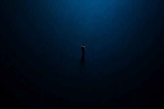 A lone figure stands dwarfed by an expansive, deep blue, mysterious backdrop, evoking feelings of profound solitude and contemplation within a vast, abstract space