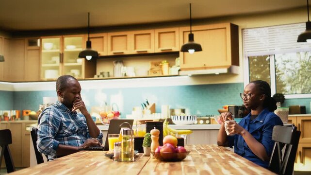 African american guy trying to catch attention of absent zoned out lover, detached woman being defocused and dissociated from her boyfriend over morning coffee. Disconnected girl. Camera A.