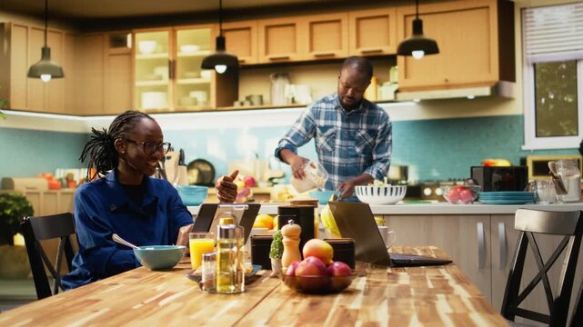 African American man and woman using online retail app for grocery shopping. Selecting and buying products for daily use, ordering perishable and nonperishable items for balanced lifestyle. Camera A.