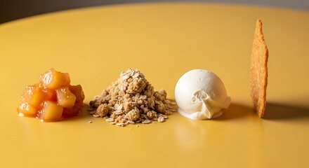 A deconstructed apple crumble dessert with vanilla ice cream and a crisp biscuit plated on a bright yellow surface.