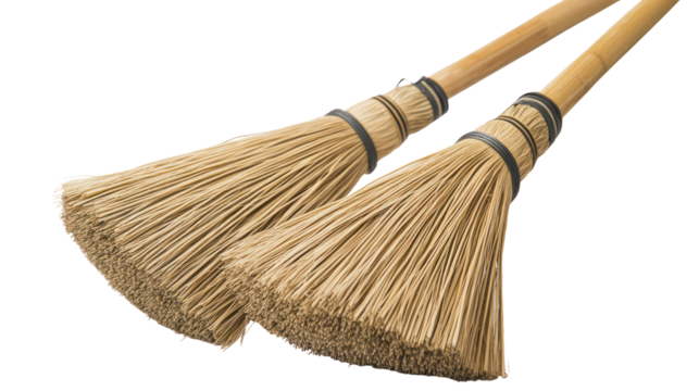 Two rustic brooms with wooden handles isolated on transparent background