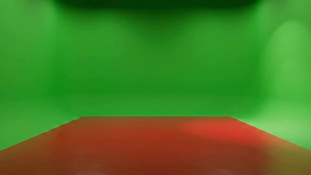 Empty Green Screen Studio With Red Floor Dramatic Lighting For Chroma Key Effects And Virtual Production
