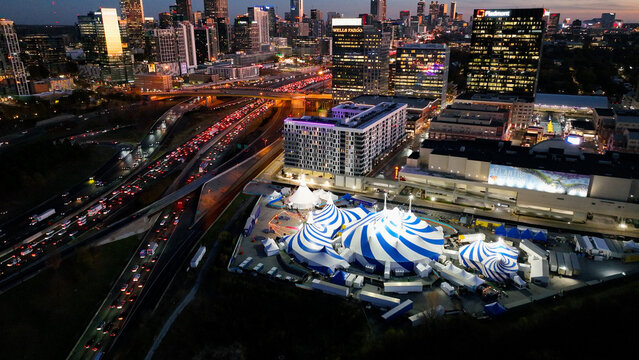 Amazing aerial drone photo of Atlanta skyline and Cirque du Soleil Atlanta 2025. Shot during the golden hour with amazing orange evening lighting and electric city lights. Shot 11 14 2025 in Atlanta