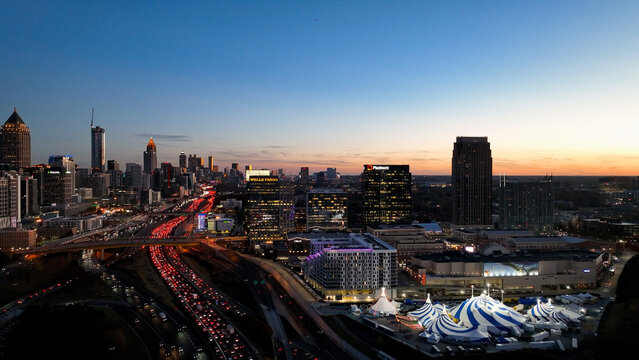 Amazing aerial drone photo of Atlanta skyline and Cirque du Soleil Atlanta 2025. Shot during the golden hour with amazing orange evening lighting and electric city lights. Shot 11 14 2025 in Atlanta