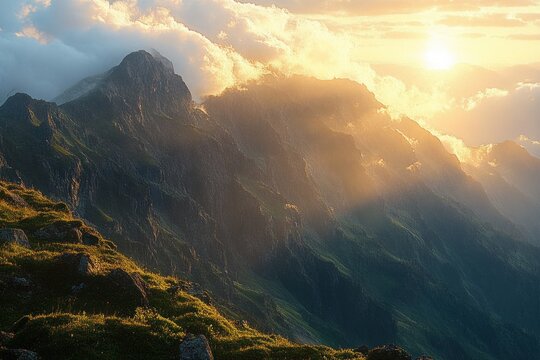 sunlit rugged mountain ridge with grassy foreground, dramatic clouds and golden rays at sunrise conveying a serene majestic atmosphere - Powered by Adobe