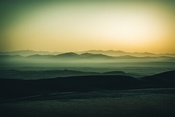 Obraz premium Hazy mountain range at dusk with gradient sky and atmospheric perspective