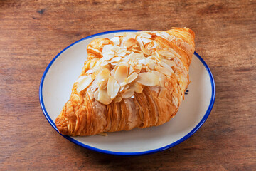 Almond butter croissant on white plate   