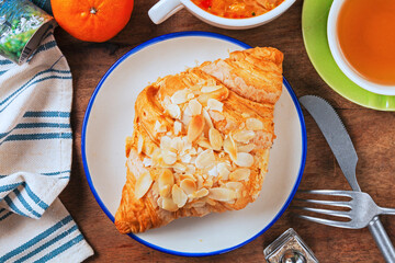 Almond butter croissant on white plate   