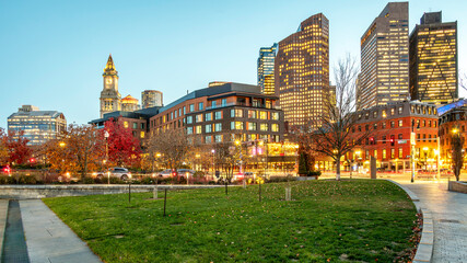 The iconic city of Boston in Massachusetts, USA at sunset with its skyline full of skyscrapers. gardens and lights on a clear winter night.