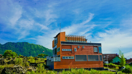 beautiful view of a village at the foot of a hill covered in mist