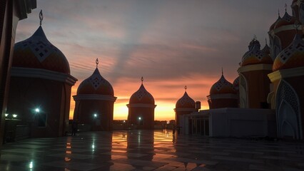 silhouettes of mosque at sunset