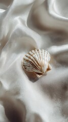Serene Still Life of a Textured Seashell on a Luminous White Silk Drape.