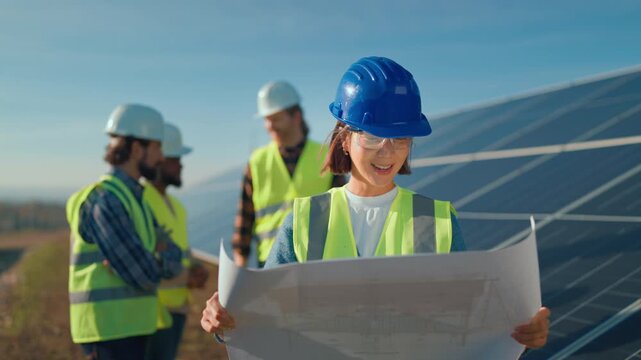 Solar energy project team reviews plans for installation at a site in sunny California on a clear day