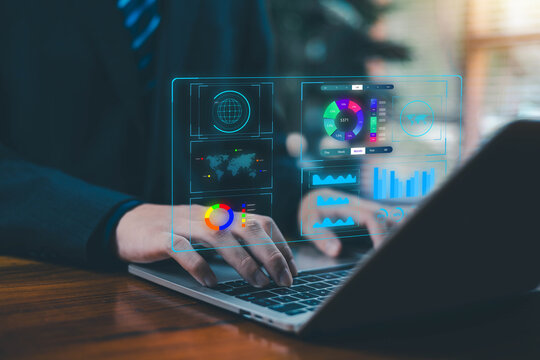Businessman using laptop with futuristic data dashboard interface, analytics charts, graphs, and digital technology elements. Ideal for business intelligence, big data, fintech, and digital.