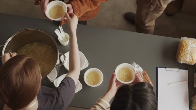 Volunteers Serving Hot Soup to People in Need