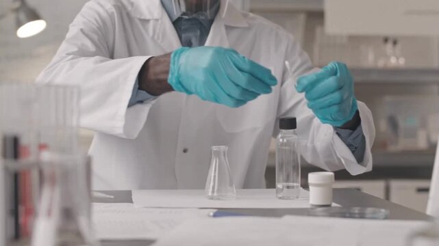 Chemist Mixing Chemicals and Watching a Bubbling Reaction