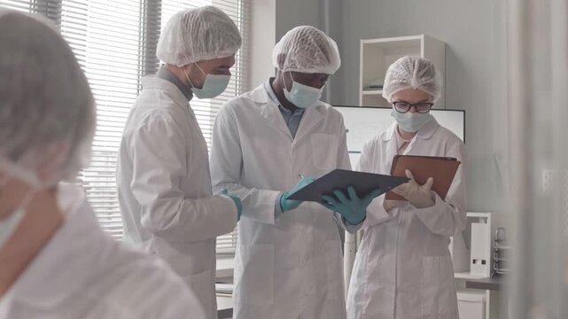 Scientists Discuss Research Findings Inside a Modern Laboratory