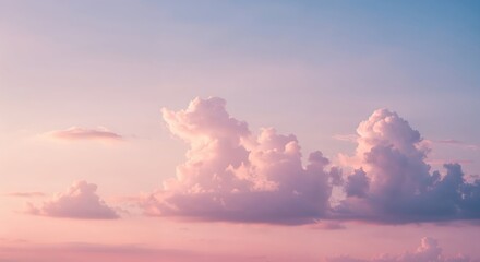 Obraz premium Sunset Hues: Sky is painted with soft pastel shades of pink and blue, with fluffy clouds drifting across the expanse. The colors create a sense of tranquility.