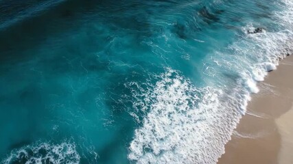 Aerial view of turquoise ocean waves crashing on sandy beach with white foam creating natural patterns - Powered by Adobe
