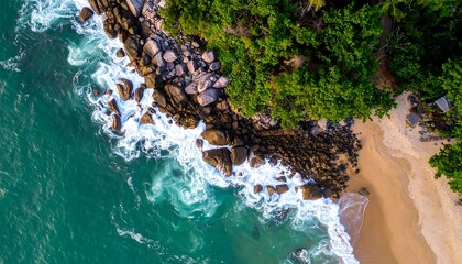 Aerial shot of turquoise waves crashing on a sandy shore next to rocky cliffs covered in lush green trees