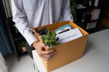 Employees put things in boxes in the office. After resigning from work