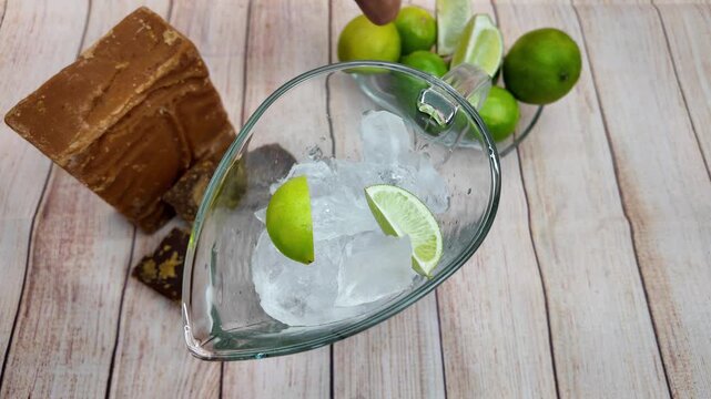 Overhead insert shot raw cane sugar Panela Piloncillo and fresh limes used to create the classic, sweet, and refreshing South American drink.