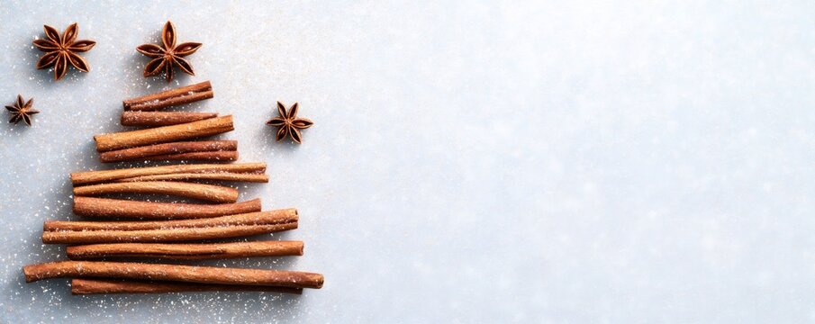 Holiday concept showing a creative christmas tree design using cinnamon sticks and star anise with copy space