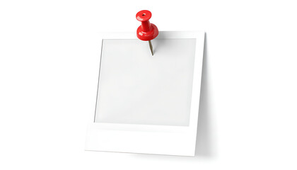 Blank polaroid picture attached with a red push pin on a white surface in a studio setting