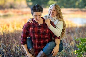 Fototapeta premium couple sharing joyful lakeside activity, friends participating in lively outdoor group activity by water