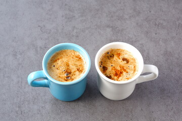 Two cups of café au lait,“coffee with milk” in French on white table
