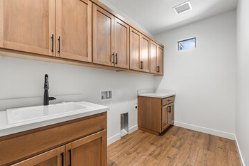 Fototapeta premium In a laundry room, there are two blue washers and matching dryers