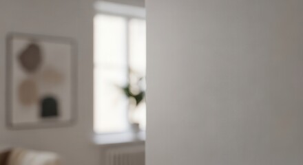 Minimalist interior space displays soft abstract artwork near a brightly lit window